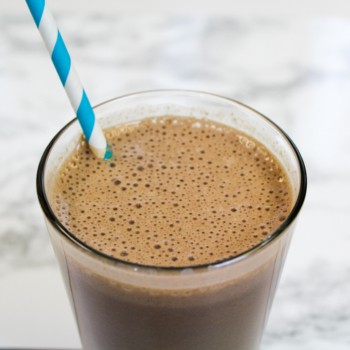 Mocha smoothie in a glass with a straw.