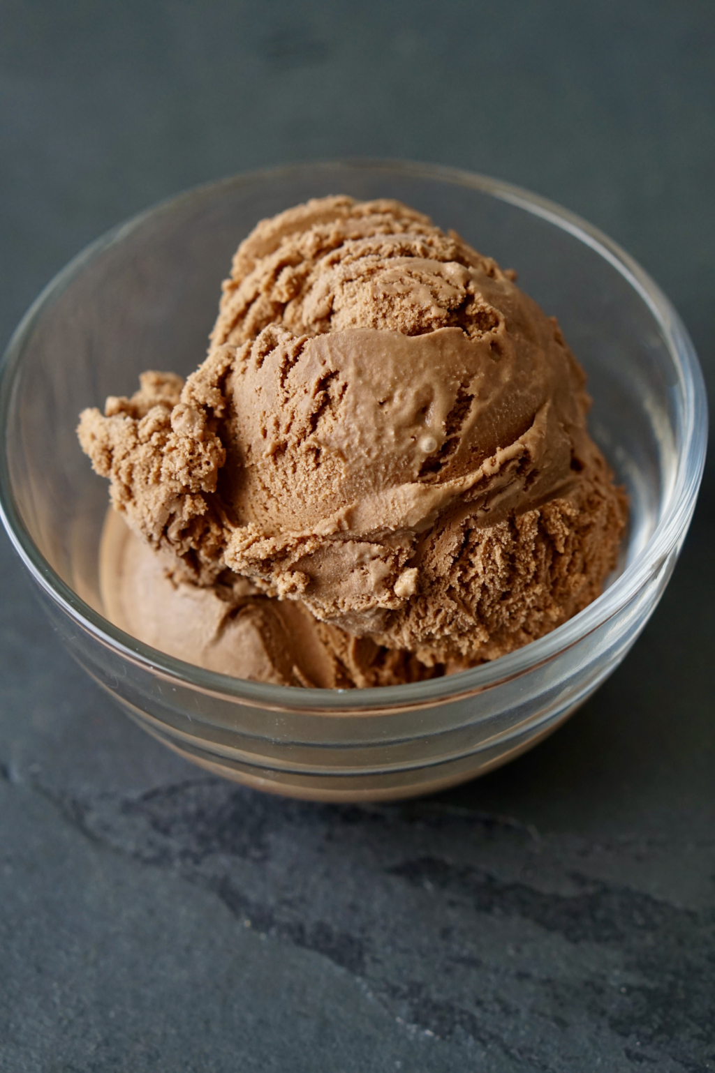 Bowl of mocha ice cream on slate countertop.