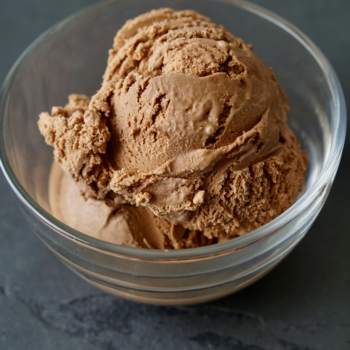Bowl of mocha ice cream on slate countertop.