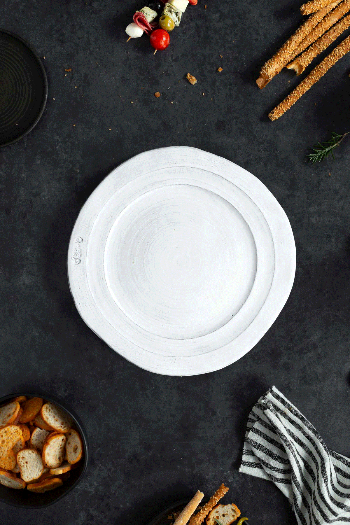 GIF showing the assembly of a holiday antipasto wreath.