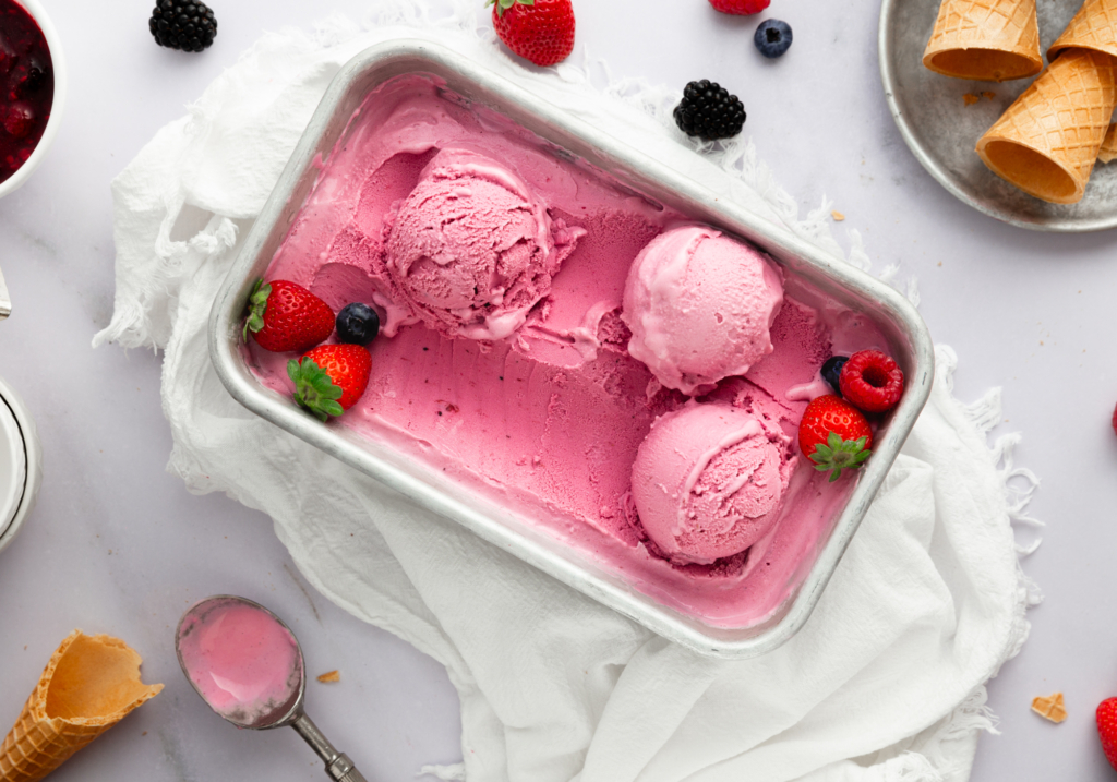 Container of berry ginger frozen yogurt scooped into balls