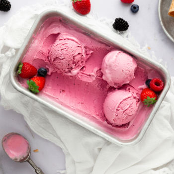 Container of berry ginger frozen yogurt scooped into balls