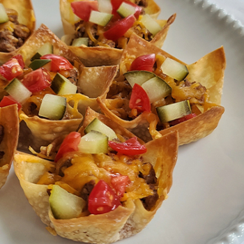 Image of cheeseburger tarts on a plate.