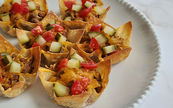 Image of cheeseburger tarts on a plate.