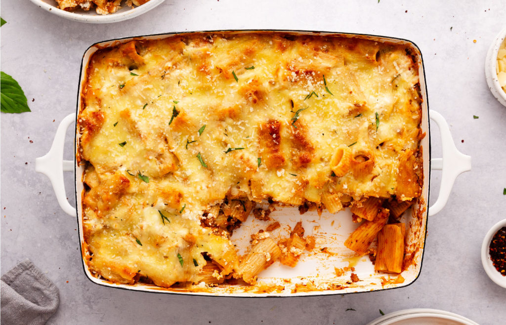 Image of a cheesy pasta bake in a pan.