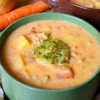 Image of cheesy turkey burger chowder in a soup crock.