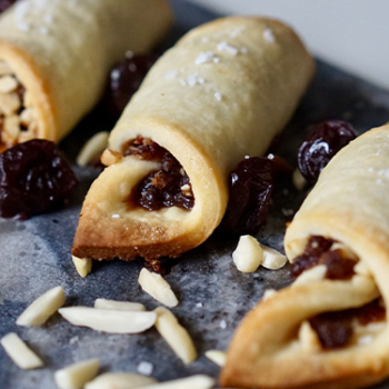 Image of cherry almond rugalachs on a serving platter.