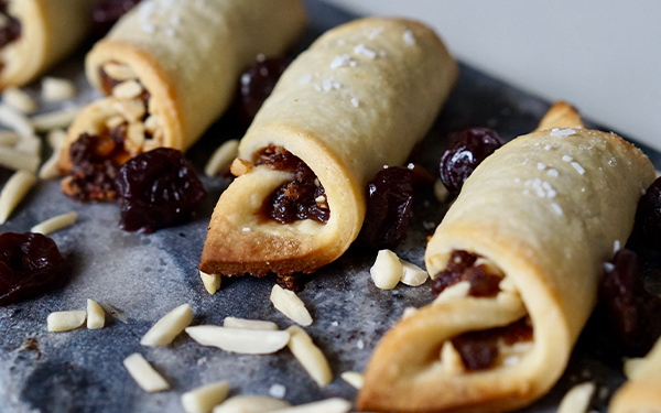 Image of cherry almond rugalachs on a serving platter.