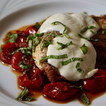 Image of chicken caprese on a plate.