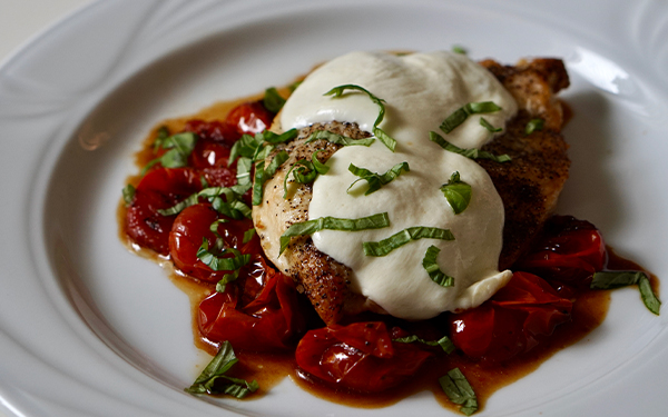 Image of chicken caprese on a plate.