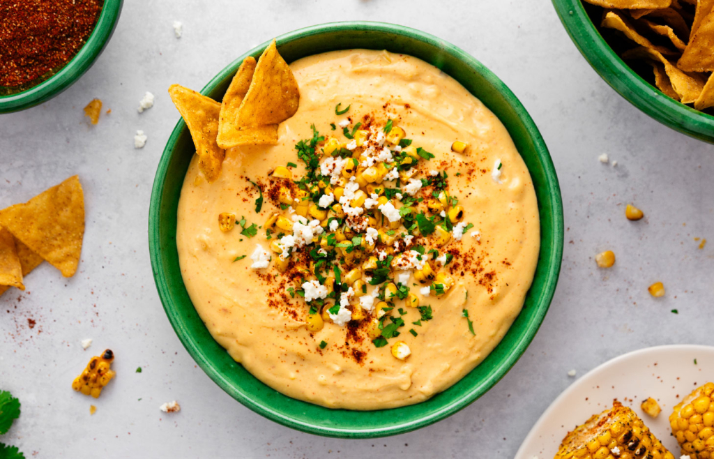 Overhead image of creamy elote dip in a bowl.