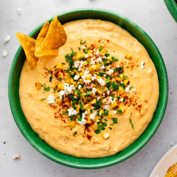 Overhead image of creamy elote dip in a bowl.