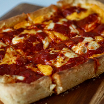 Image of Detroit style pizza on a cutting board.