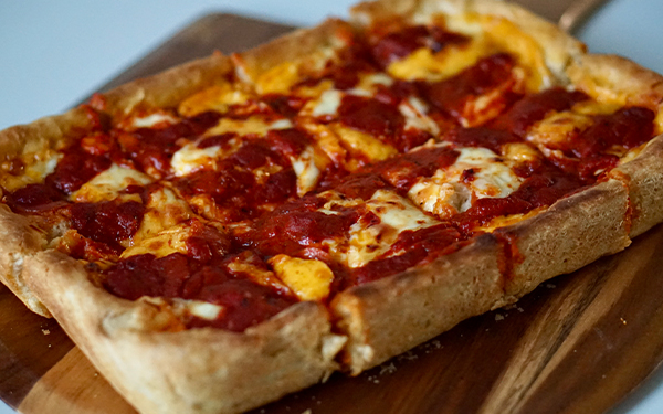 Image of Detroit style pizza on a cutting board.