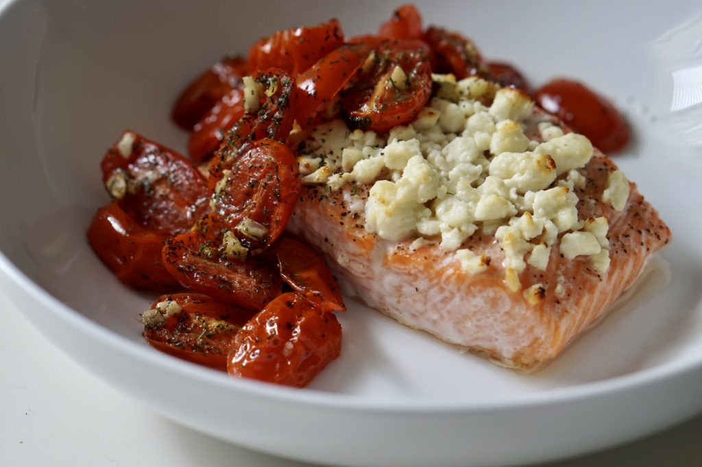 Image of roasted salmon topped with feta cheese and roasted tomatoes.