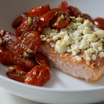 Image of roasted salmon topped with feta cheese and roasted tomatoes.