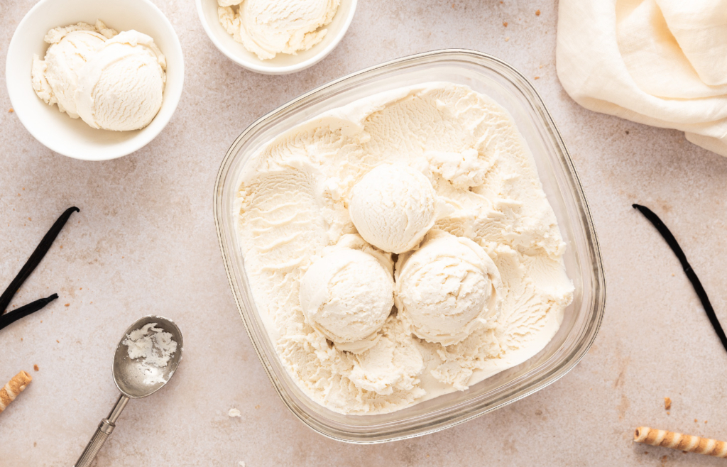 Image of a container of creamy, frozen custard ready to be scooped into bowls.