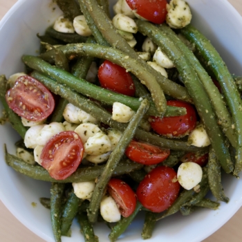 Overhead image of a green bean and tomato salad.