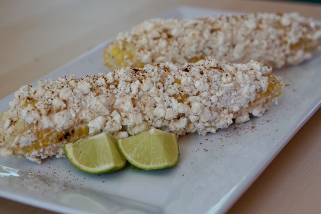 Image of two cobs of grilled street corn.