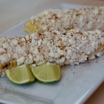 Image of two cobs of grilled street corn.