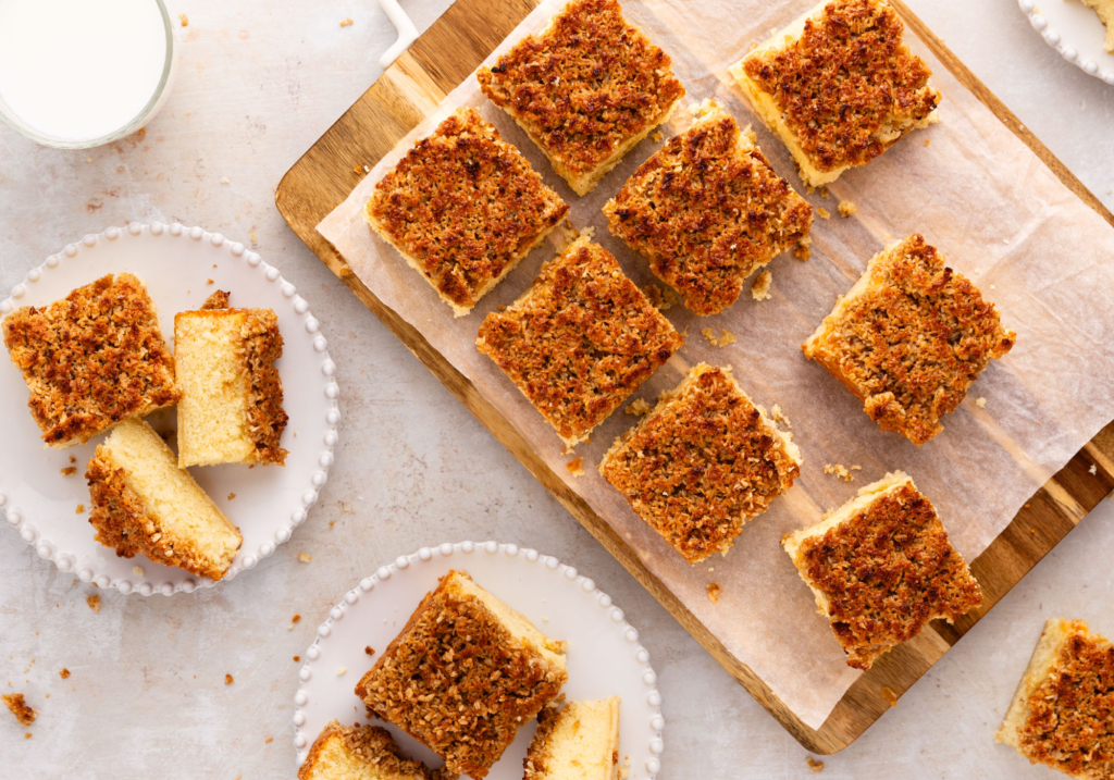 Overhead image of hot milk cake slices on a cutting board and plates.