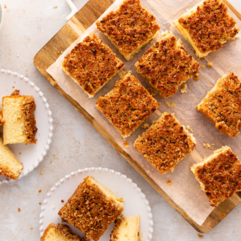 Overhead image of hot milk cake slices on a cutting board and plates.