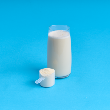 Scoop of why protein and a glass of mixed protiend on a bright blue background.