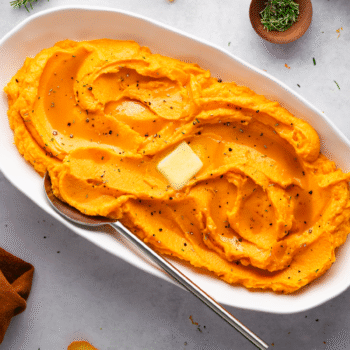 Image of a serving dish filled with mashed maple-whipped sweet potatoes.